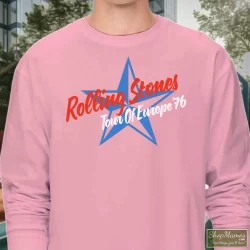 1976 Rolling Stones Tour Of Europe T Shirt 7 Men's 1976 Rolling Stones Tour Of Europe Long Sleeve In Light Pink, Front View On Dark Wood Background