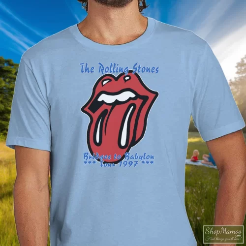 90s 1997 Rolling Stones Rock Tour Bridges To Babylon Men’s T Shirt – Light Blue Front View On Dark Wood Background Men's 90s 1997 Rolling Stones Rock Tour Bridges To Babylon T Shirt In Light Blue, Front View On Dark Wood Background