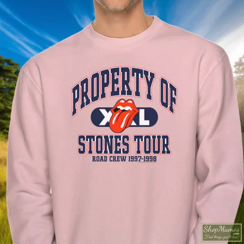90s Rolling Stones Property Of Stones Tour Men’s Sweatshirt – Light Pink Front View On Dark Wood Background Men's 90s Rolling Stones Property Of Stones Tour Sweatshirt In Light Pink, Front View On Dark Wood Background