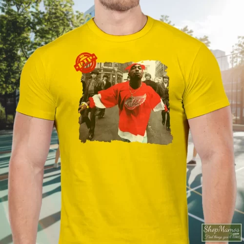 90s Tupac Shakur 2pac Wearing Detroit Red Wing Jersey Hip Hop Rap Hype Dope Swag Men’s T Shirt – Yellow Front View On Dark Wood Background Men's 90s Tupac Shakur 2pac Wearing Detroit Red Wing Jersey Hip Hop Rap Hype Dope Swag T Shirt In Yellow, Front View On Dark Wood Background