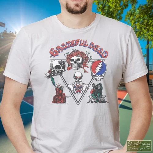 Grateful Dead Jerry Garcia 1978 Tour Men’s T Shirt – White Front View On Dark Wood Background Men's Grateful Dead Jerry Garcia 1978 Tour T Shirt In White, Front View On Dark Wood Background