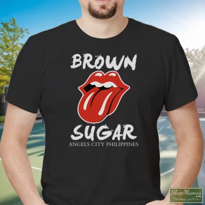 Men's The Rolling Stones Brown Sugar Angels City Philippines T Shirt In Black, Front View On Light Wood Background