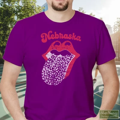 Men's Leopard Tongue Rolling Stones Style Nebraska Huskers Black T Shirt In Purple, Front View On Light Wood Background