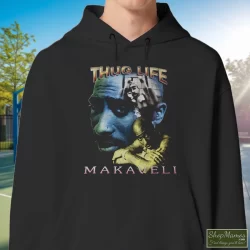 Tupac Shakur 2pac Thug Life One Year In Memory Memorial Shirt 9 Men's Tupac Shakur 2pac Thug Life One Year In Memory Memorial Hoodie In Black, Front View On Light Wood Background