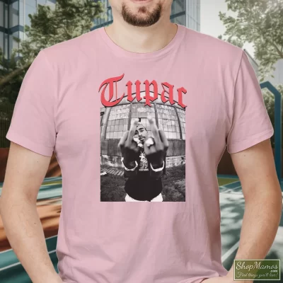 Men's Tupac Shakur Black Middle Finger T Shirt In Light Pink, Front View On Dark Wood Background