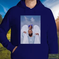 Two Angels Tupac Shakur And Nipsey Hussle Shirt 8 Men's Two Angels Tupac Shakur And Nipsey Hussle Hoodie In Navy, Front View On Light Wood Background