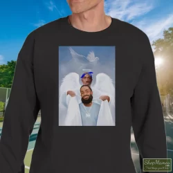 Two Angels Tupac Shakur And Nipsey Hussle Shirt 11 Men's Two Angels Tupac Shakur And Nipsey Hussle Sweatshirt In Black, Front View On Light Wood Background