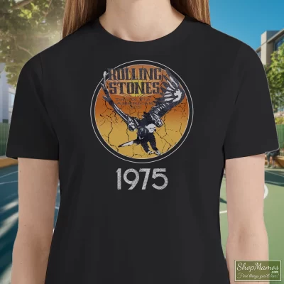 Women's 1975 Rolling Stones Tour Of The Americas Band T Shirt In Black, Front View On Light Wood Background