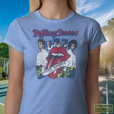 Women's 1989 Rolling Stones Steel Wheels Tour Band Rock 80s 1980s T Shirt In Light Blue, Front View On Dark Wood Background