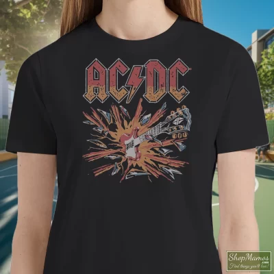 Women's AcDc Blow Up Rock T Shirt In Black, Front View On Light Wood Background