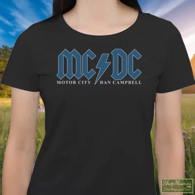 Women's Detroit Lions Mcdc Motor City Hooded Dan Campbell Acdc T Shirt In Black, Front View On Light Wood Background