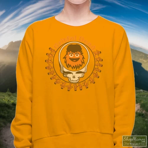 Grateful Dead Gritty Philadelphia Flyers Women’s Sweatshirt – Orange Front View On Dark Wood Background Women's Grateful Dead Gritty Philadelphia Flyers Sweatshirt In Orange, Front View On Dark Wood Background