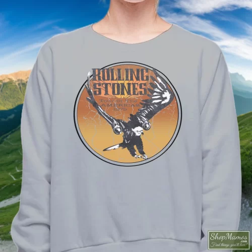 Rolling Stones 1975 Tour Of The Americas Women’s Sweatshirt – Sport Grey Front View On Dark Wood Background Women's Rolling Stones 1975 Tour Of The Americas Sweatshirt In Sport Grey, Front View On Dark Wood Background