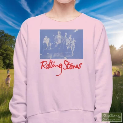 Women's Rolling Stones Black And Blue Live Sweatshirt In Light Pink, Front View On Dark Wood Background