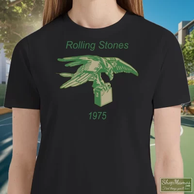 Women's Rolling Stones Eagle With Amp 1975 T Shirt In Black, Front View On Light Wood Background