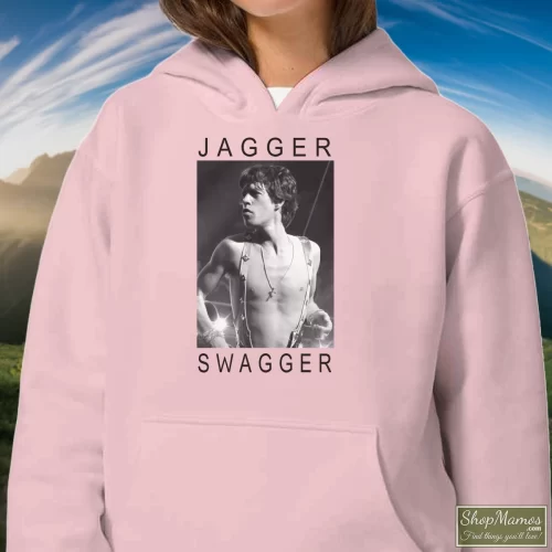Rolling Stones Mick Jagger Swagger Women’s Hoodie – Light Pink Front View On Dark Wood Background Women's Rolling Stones Mick Jagger Swagger Hoodie In Light Pink, Front View On Dark Wood Background