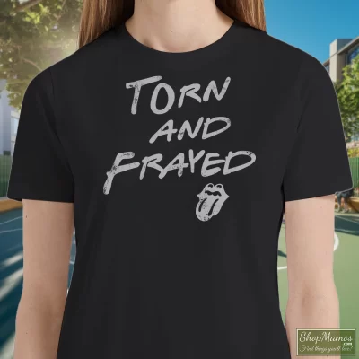 Women's Rolling Stones Torn And Frayed T Shirt In Black, Front View On Light Wood Background