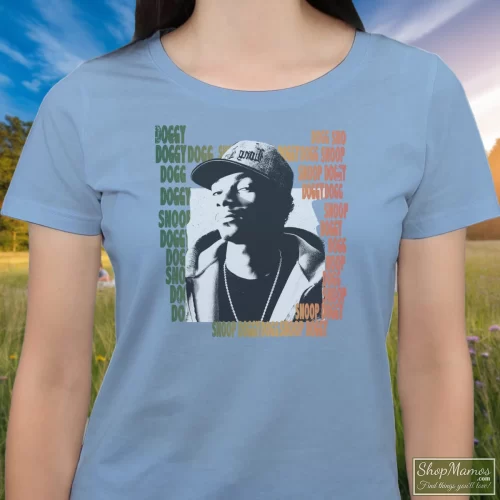 Snoop Dogg In Dirty Women’s T Shirt – Light Blue Front View On Dark Wood Background Women's Snoop Dogg In Dirty T Shirt In Light Blue, Front View On Dark Wood Background