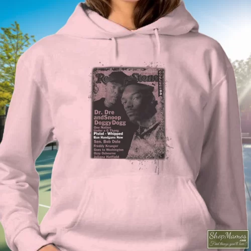 Snoop Doggy Dogg Dr Dre Rolling Stones Cover Collection 90s Women’s Hoodie – Light Pink Front View On Dark Wood Background Women's Snoop Doggy Dogg Dr Dre Rolling Stones Cover Collection 90s Hoodie In Light Pink, Front View On Dark Wood Background