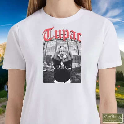 Women's Tupac Shakur Black Middle Finger T Shirt In White, Front View On Dark Wood Background