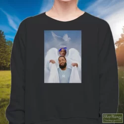 Two Angels Tupac Shakur And Nipsey Hussle Shirt 10 Women's Two Angels Tupac Shakur And Nipsey Hussle Sweatshirt In Black, Front View On Light Wood Background